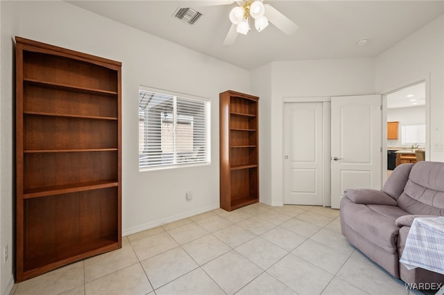 living area with a healthy amount of sunlight, visible vents, and light tile patterned flooring