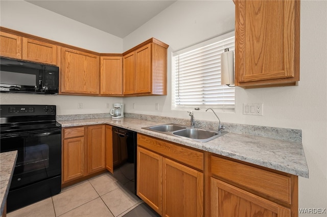 kitchen with light tile patterned floors, light stone counters, a sink, black appliances, and brown cabinetry