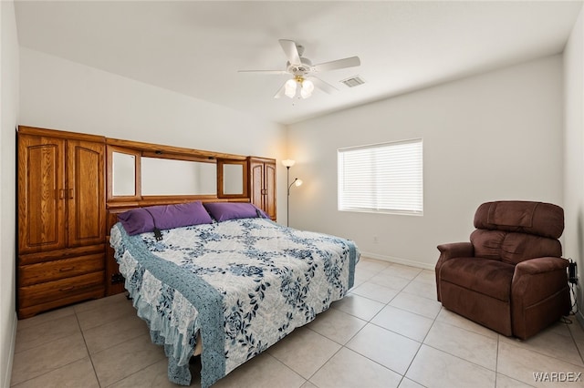 bedroom with ceiling fan, light tile patterned flooring, visible vents, and baseboards