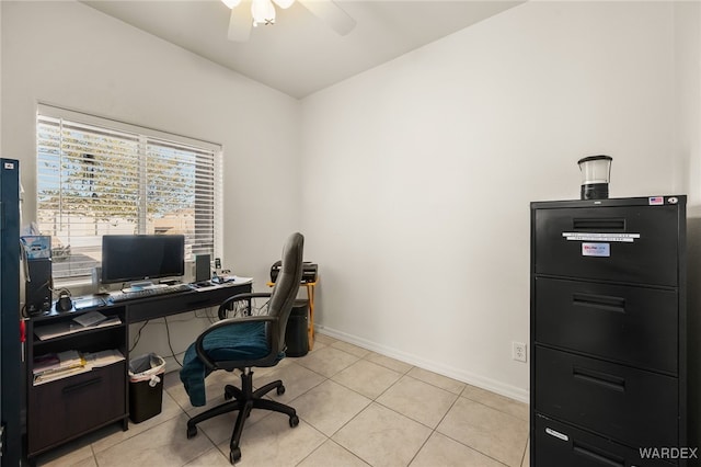 office space with ceiling fan, baseboards, and light tile patterned flooring