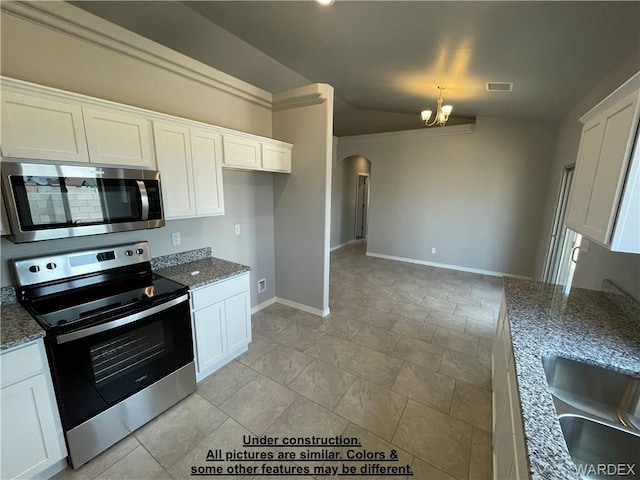 4939 N Famoso Dr, Kingman, AZ 86409 - kitchen with appliances with stainless steel finishes, arched walkways, baseboards, a chandelier, and white cabinets