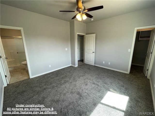 4939 N Famoso Dr, Kingman, AZ 86409 - unfurnished bedroom with carpet flooring, a walk in closet, baseboards, ensuite bathroom, and ceiling fan