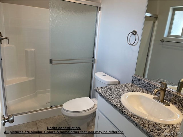 4939 N Famoso Dr, Kingman, AZ 86409 - full bath featuring a stall shower, toilet, tile patterned floors, and vanity