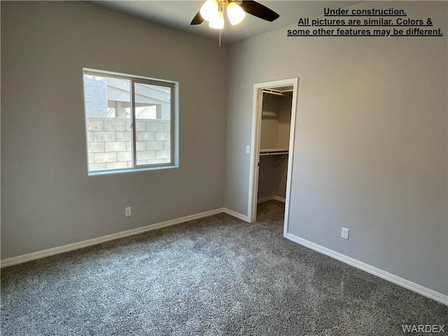 4939 N Famoso Dr, Kingman, AZ 86409 - unfurnished bedroom with carpet flooring, a spacious closet, baseboards, a ceiling fan, and a closet