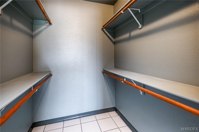 spacious closet featuring light tile patterned floors