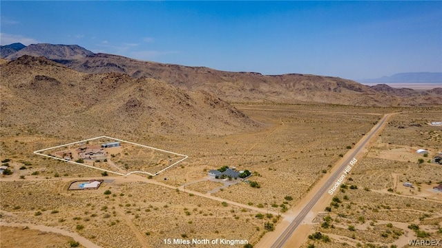 birds eye view of property with a mountain view and a desert view