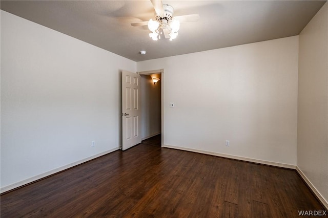 unfurnished room with ceiling fan, baseboards, and dark wood-type flooring