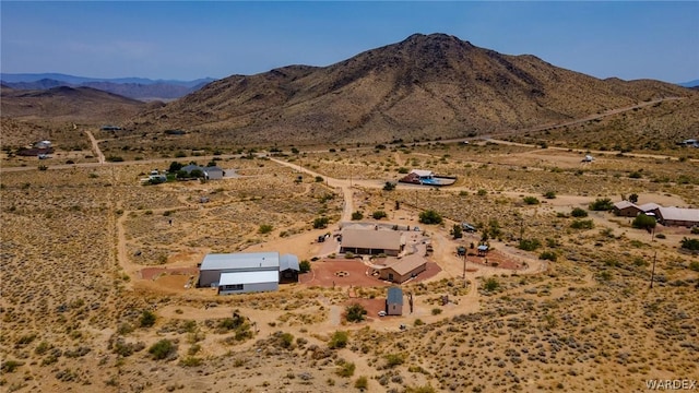 birds eye view of property featuring view of desert and a mountain view