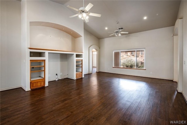 unfurnished living room with arched walkways, recessed lighting, visible vents, a ceiling fan, and dark wood-style floors