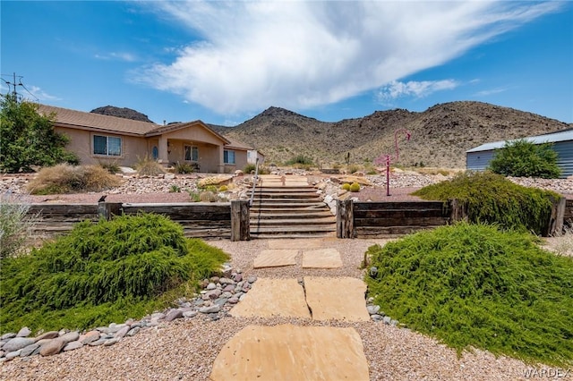 single story home with fence and a mountain view