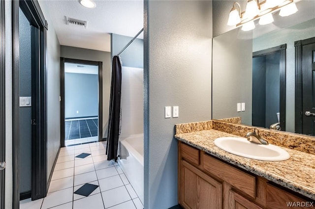 full bathroom featuring shower / tub combo with curtain, visible vents, toilet, vanity, and tile patterned flooring