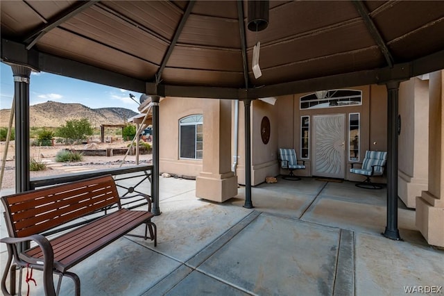 view of patio / terrace featuring a gazebo and a mountain view