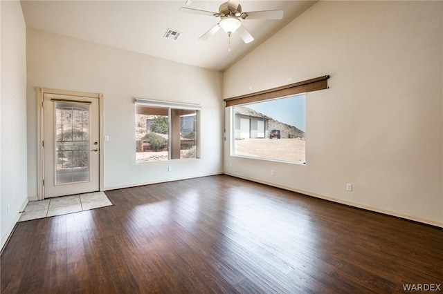 unfurnished room featuring a ceiling fan, visible vents, baseboards, and wood finished floors