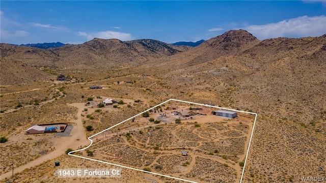 birds eye view of property featuring view of desert and a mountain view