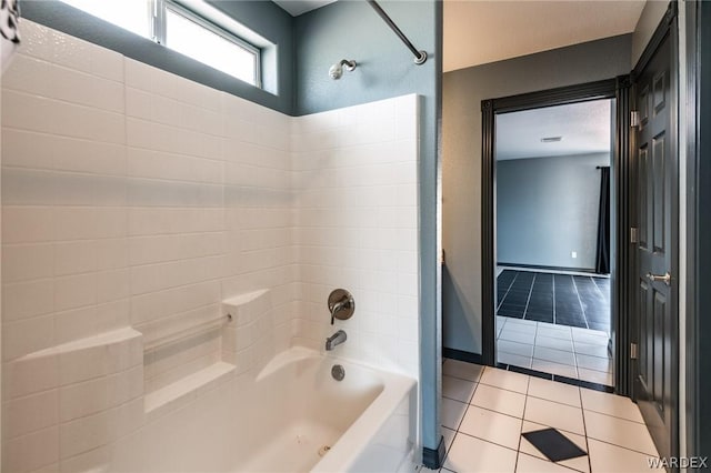 full bath featuring tile patterned floors, baseboards, and shower / bathing tub combination