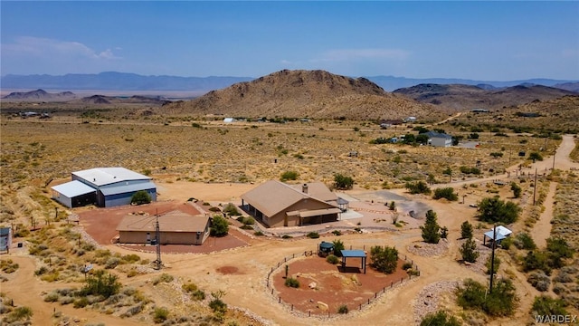 aerial view featuring a desert view and a mountain view