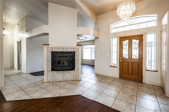 foyer entrance with a chandelier, a high ceiling, and light tile patterned floors