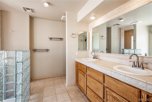 bathroom featuring double vanity, a sink, and visible vents