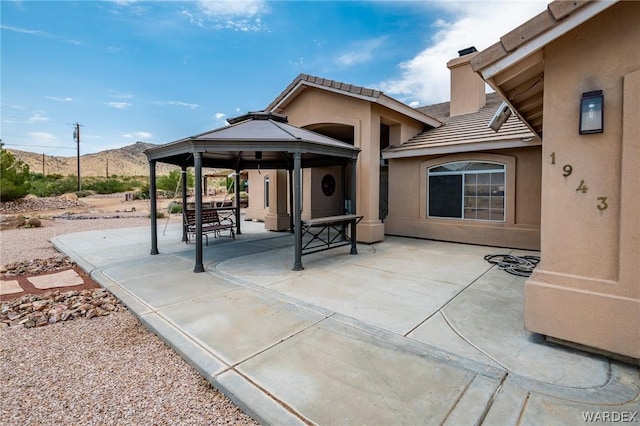 view of patio / terrace featuring a mountain view and a gazebo