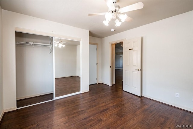 unfurnished bedroom with a ceiling fan, baseboards, dark wood finished floors, and a closet