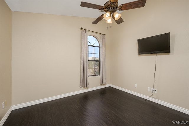 unfurnished room with wood finished floors, a ceiling fan, and baseboards