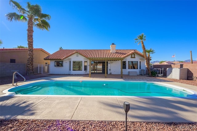 view of swimming pool featuring a patio area, fence, and a fenced in pool