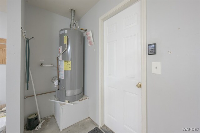 utility room with gas water heater