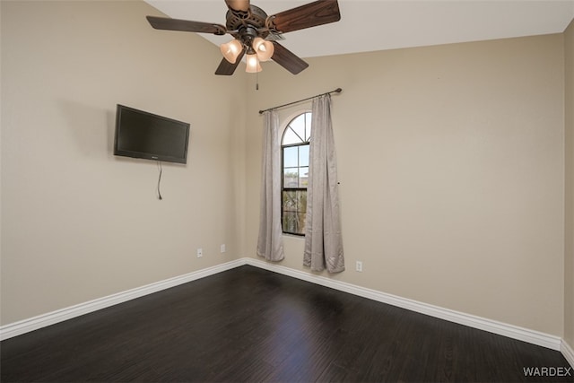 empty room with ceiling fan, baseboards, and wood finished floors