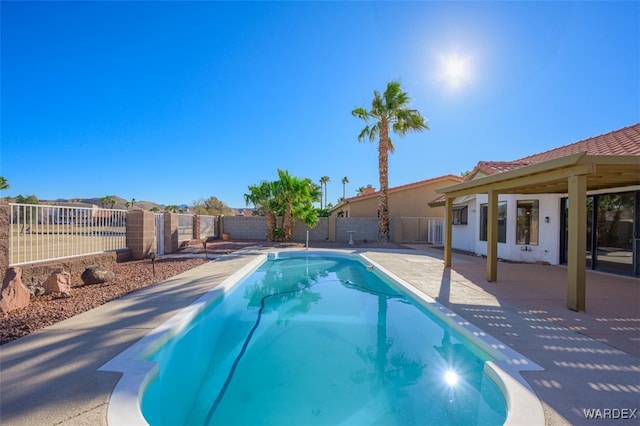 view of swimming pool with a fenced in pool, a fenced backyard, and a patio