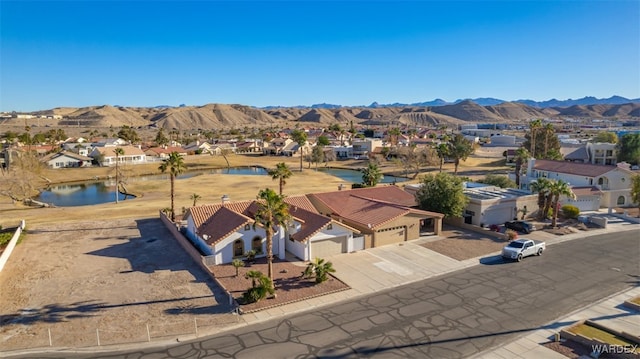 birds eye view of property featuring a residential view and a water and mountain view