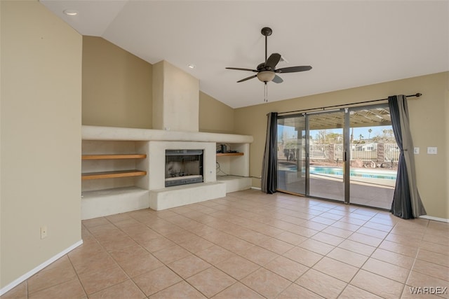 unfurnished living room with a fireplace with raised hearth, a ceiling fan, light tile patterned flooring, vaulted ceiling, and baseboards