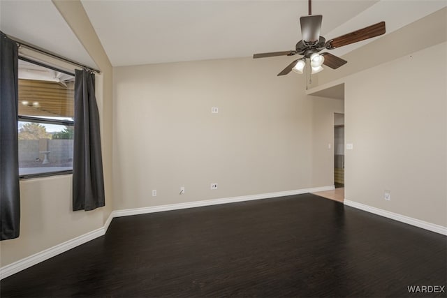 spare room featuring a ceiling fan, lofted ceiling, baseboards, and wood finished floors