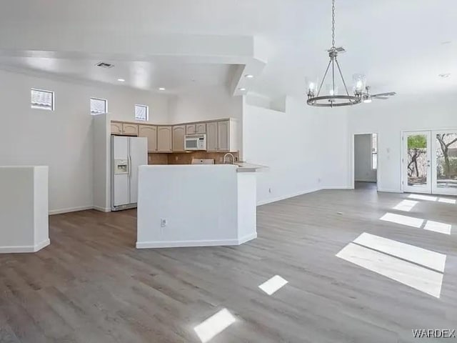 kitchen featuring a chandelier, white appliances, visible vents, and open floor plan