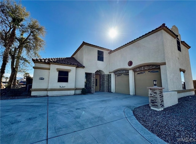 view of side of property with a garage, a tile roof, driveway, and stucco siding