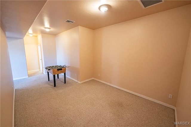 carpeted empty room featuring visible vents and baseboards