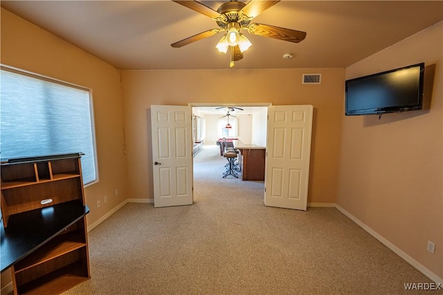 bedroom featuring light carpet, baseboards, visible vents, and a ceiling fan