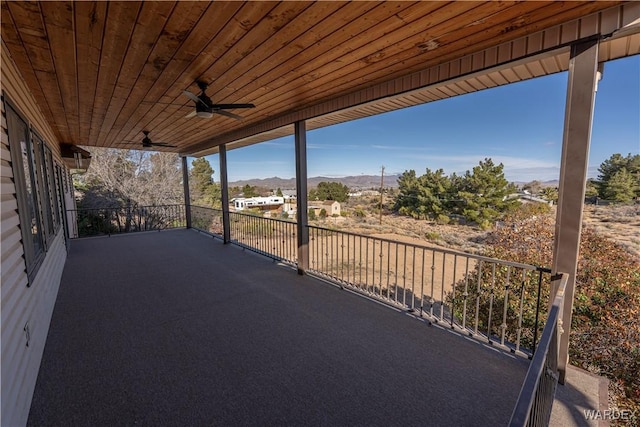 view of patio with ceiling fan and a mountain view