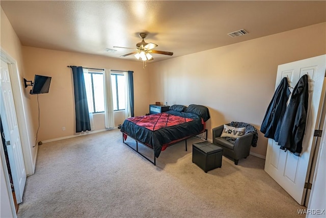 carpeted bedroom with ceiling fan, visible vents, and baseboards