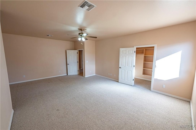 unfurnished room with light carpet, visible vents, and baseboards