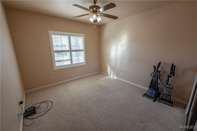 spare room featuring carpet floors, baseboards, and a ceiling fan