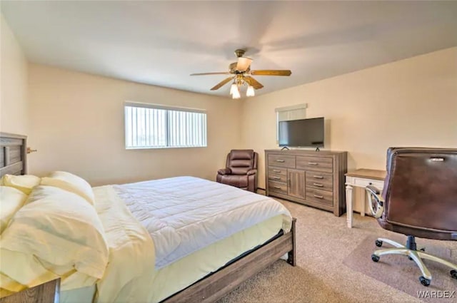 bedroom with light carpet and a ceiling fan