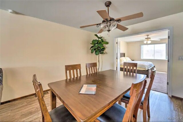 dining room featuring baseboards and light wood-style floors