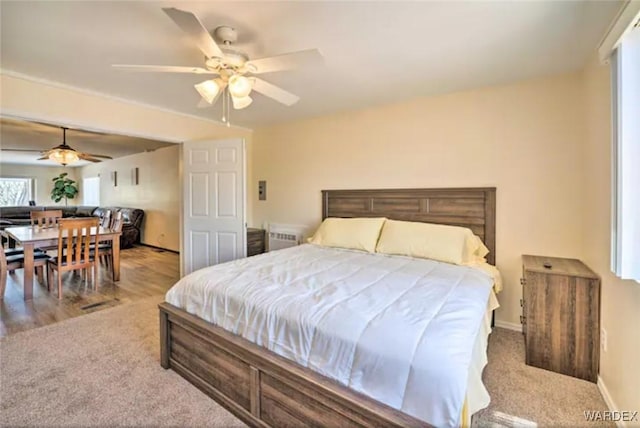 bedroom featuring light carpet and baseboards