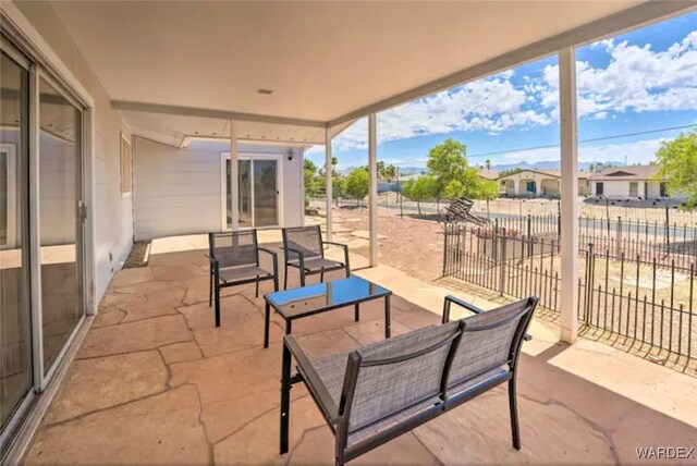 view of patio featuring fence