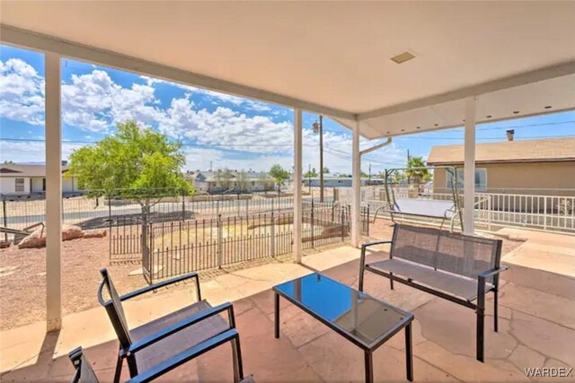 view of patio featuring fence