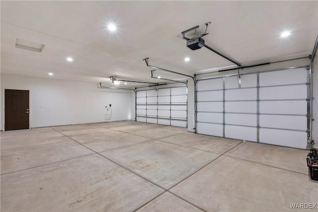 garage featuring a garage door opener and recessed lighting