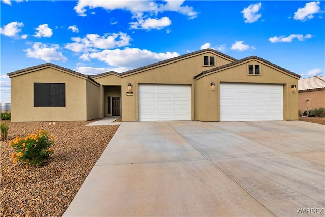 single story home featuring driveway, an attached garage, a tile roof, and stucco siding