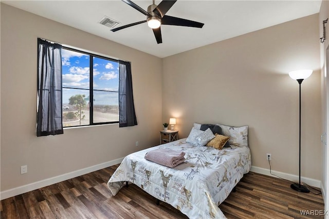 bedroom featuring a ceiling fan, baseboards, visible vents, and dark wood-type flooring