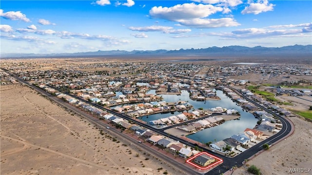 drone / aerial view featuring a water and mountain view