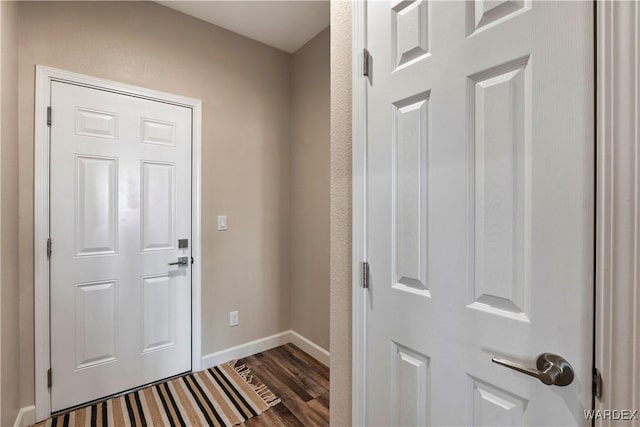 entryway featuring dark wood-style floors and baseboards